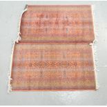 PAIR OF MIDDLE EASTERN STYLE PRAYER MATS each with elaborate decoration on a pink ground, fringed,