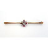 DIAMOND AND RUBY CLUSTER SET BAR BROOCH in nine carat gold, 5.