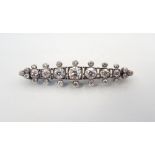 IMPRESSIVE EDWARDIAN DIAMOND BROOCH the seven graduated diamonds in a further surround of smaller