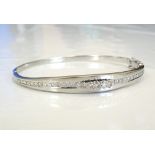 DIAMOND SET WHITE GOLD BANGLE the central raised graduated diamonds flanked by further channel set