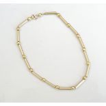 EIGHTEEN CARAT GOLD BRACELET with alternating balls and tubes,