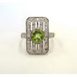 ART DECO STYLE PERIDOT AND DIAMOND DRESS RING the central round cut peridot in multi diamond