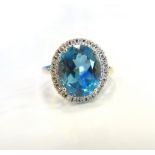 BLUE ZIRCON AND DIAMOND DRESS RING the large central stone in diamond surround,