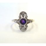 ART DECO STYLE AMETHYST AND DIAMOND RING the central round cut amethyst in shaped pierced surround