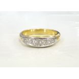 GRADUATED DIAMOND SIX STONE RING on heavy eighteen carat gold shank,