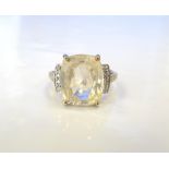 YELLOW SAPPHIRE AND DIAMOND DRESS RING the large central cushion cut sapphire approximately 5.