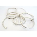 SEVEN SILVER BANGLES of various designs,