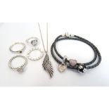 SELECTION OF 'PANDORA' JEWELLERY comprising a black double braided charm bracelet with three charms;