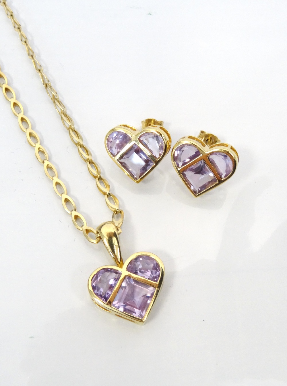 AMETHYST SET HEART DESIGN PENDANT AND MATCHING EARRINGS all in nine carat gold,