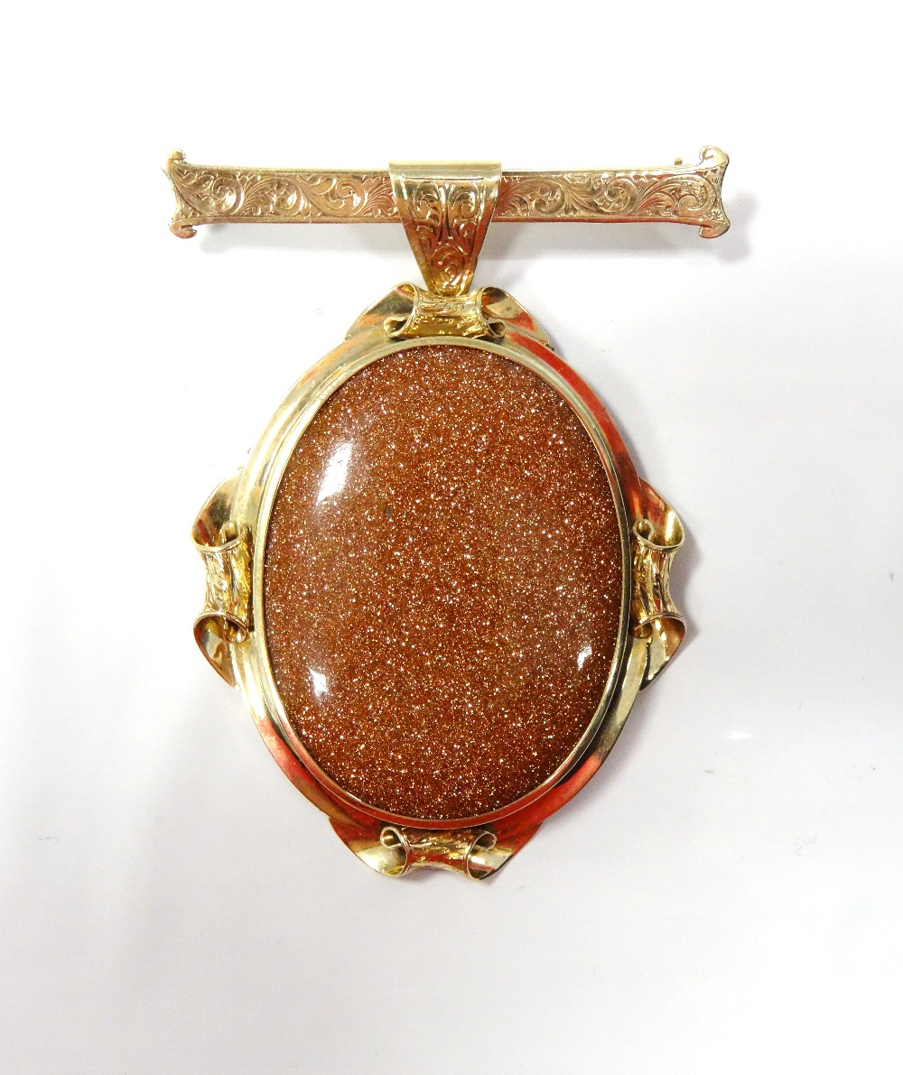 GOLDSTONE SET BROOCH the gold stone drop section in unmarked gold mount,