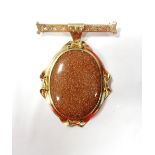 GOLDSTONE SET BROOCH the gold stone drop section in unmarked gold mount,