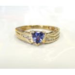 TANZANITE AND DIAMOND RING the central trillion cut tanzanite flanked by diamonds,