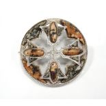 SCOTTISH AGATE SET CIRCULAR BROOCH in unmarked silver, with raised central cross section, 4.