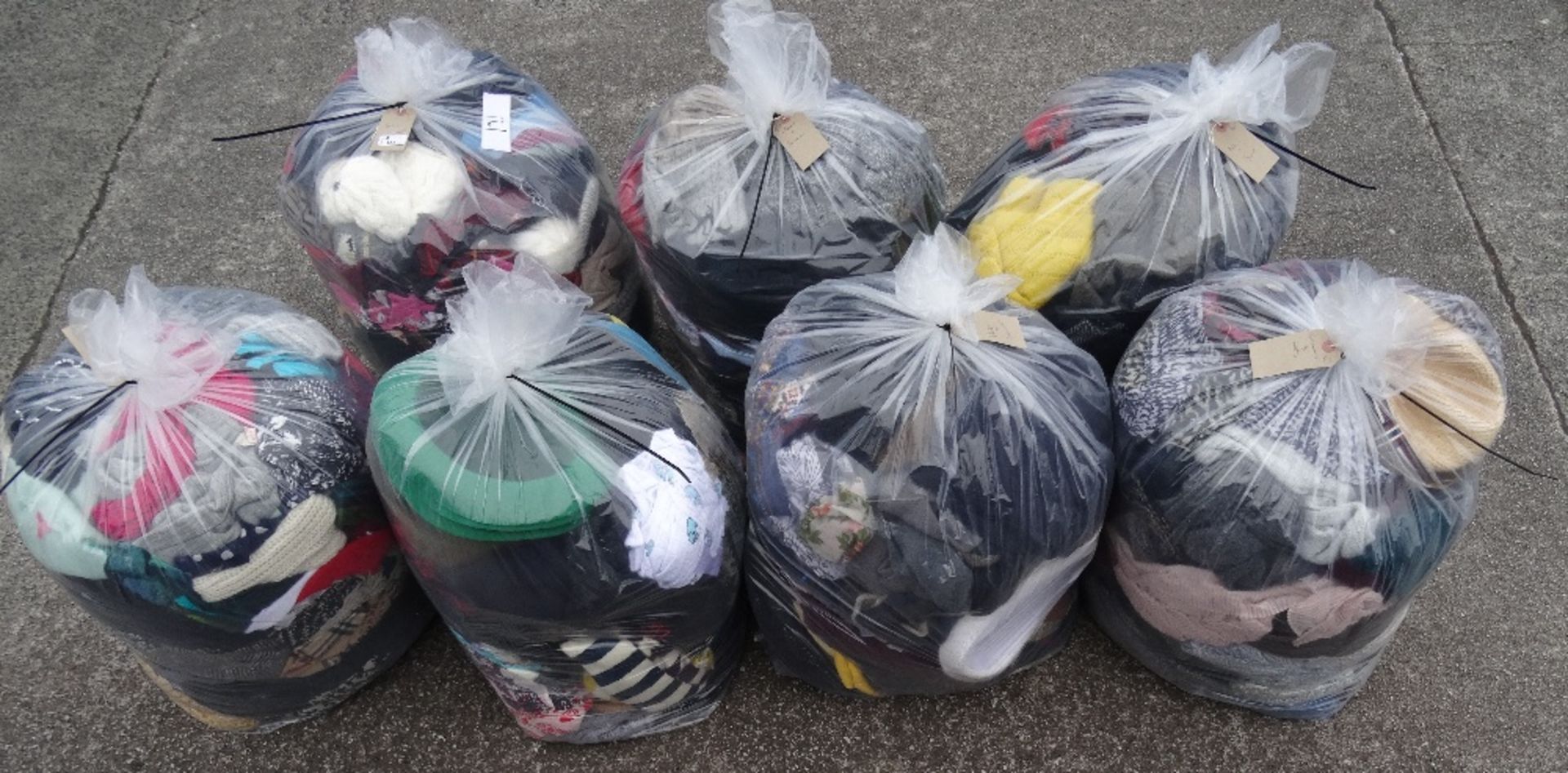 SEVEN BAGS OF HATS, SCARVES AND GLOVES