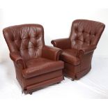 PAIR OF LEATHER ROCKING ARM CHAIRS with button back detail and scroll arms above a shaped seat,