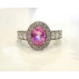 IMPRESSIVE PINK SAPPHIRE AND DIAMOND RING the central oval cut pink sapphire approximately 1.