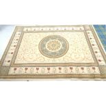 LARGE RUG with a camel coloured ground and a circular central medallion surrounded by scrolls,