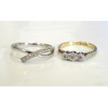 TWO DIAMOND RINGS one with nine diamonds in twist setting, on nine carat white gold shank,