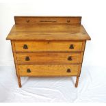 OAK CHEST the raised back above a moulded top with three drawers with carved detail,