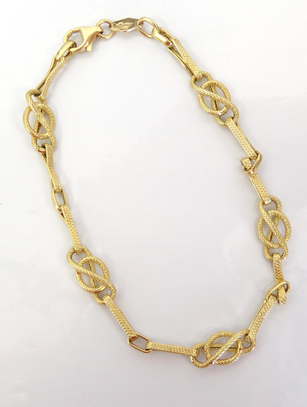 EIGHTEEN CARAT GOLD FANCY LINK BRACELET with textured finish, approximately 2.