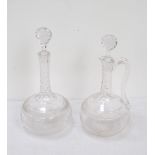 TWO GLASS DECANTERS matching in style, one with handle, with shaped necks,