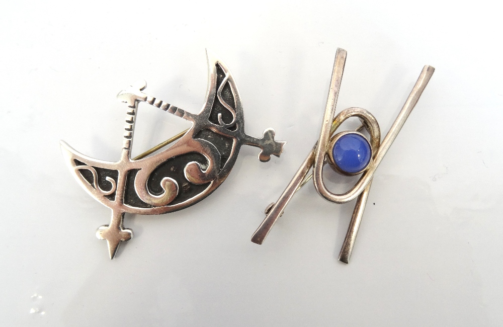 TWO OLA MARIE GORIE SILVER BROOCHES one in the form of a crescent moon and pair of compasses,