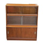 'THE SIMPLEX' SECTIONAL BOOKCASE in mahogany with a shaped edge top above two sections with glass