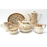 FOSTERS POTTERY PART TEA SERVICE decorated in mottled brown and comprising cups and oval saucers,