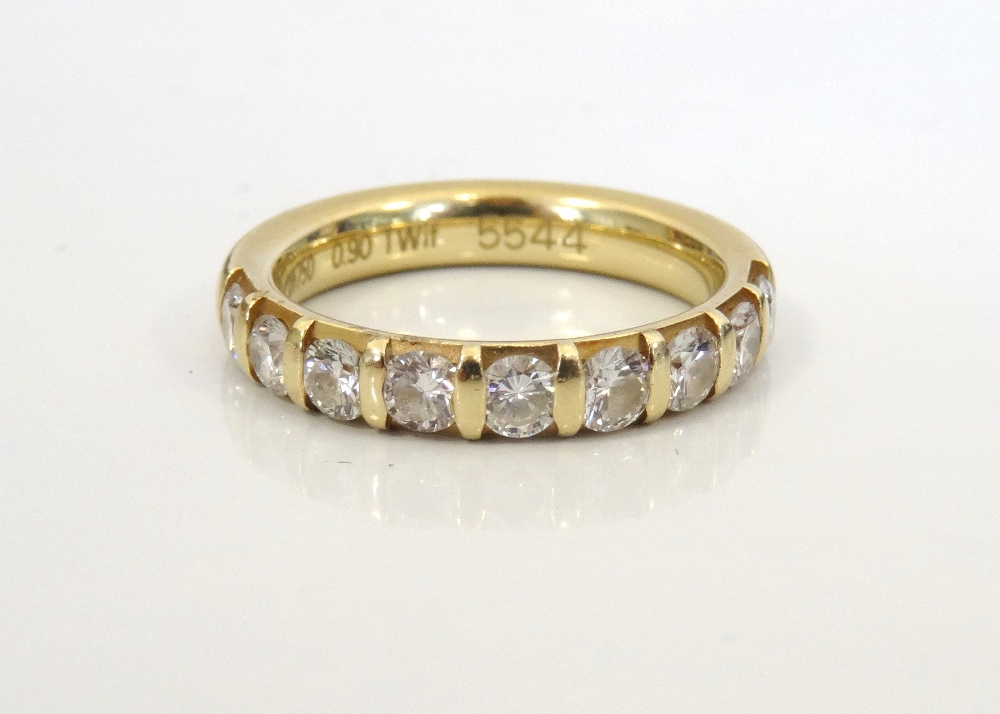 DIAMOND NINE STONE HALF ETERNITY RING in eighteen carat gold,