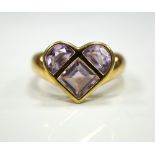 AMETHYST DRESS RING the amethysts in heart shaped setting, on nine carat gold shank,
