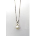 PEARL AND DIAMOND PENDANT the single pearl below three diamonds,