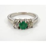 EMERALD AND DIAMOND THREE STONE RING the central round brilliant cut emerald approximately 0.