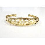 NINE CARAT GOLD BANGLE with pierced and entwined Celtic style decoration, approximately 6.