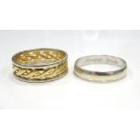 TWO GENTLEMEN'S NINE CARAT GOLD RINGS one in white and yellow gold with central twist design band,