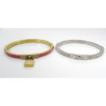 TWO MICHAEL KORS BRACELET one on gold tone with pink enamel and the other in silver tone,