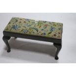 A GEORGIAN STYLE MAHOGANY FRAMED FOOT STOOL of rectangualr form with tapestry upholstered insert on