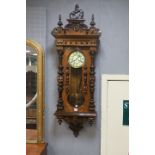 A VICTORIAN WALNUT VENEERED WALL CLOCK the Neoclassical style cornice headed by a horse above the