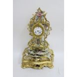 A FRENCH GLAZED PORCELAIN MANTLE CLOCK the profusely scrolled frame with gilded highlights and