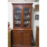 A VICTORIAN MAHOGANY BOOKCASE the moulded cornice above a plain frieze the pair of glazed panelled