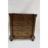 A VICTORIAN MAHOGANY BOWED BREAK FRONT CHEST the plain top above two cock beaded drawers with a