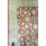 A RECTANGULAR WOOL RUG the yellow ground with central rust panel and border filled with classical