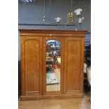 AN EARLY 20th CENTURY MAHOGANY FRAMED THREE DOOR WARDROBE the moulded cornice above a plain frieze