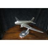 A CHROME MODEL OF AN AEROPLANE shown on an oval foot 29cm x 55cm x 35cm