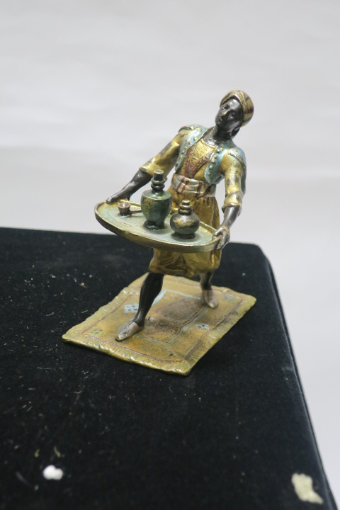 A BRONZE AND POLYCHROME FIGURE, modelled as a waiter shown standing holding a tray, stamped, Gesc...