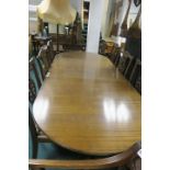 A REGENCY STYLE MAHOGANY DINING TABLE the rectangular top with rounded ends and one loose leaf on