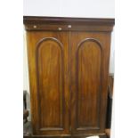 A VICTORIAN MAHOGANY TWO DOOR WARDROBE