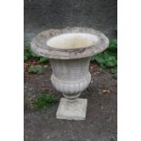 A PAIR OF STONE CAMPANA SHAPED GARDEN URNS,