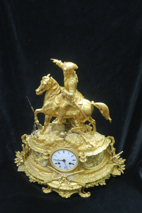 A FINE FRENCH GILT METAL CLOCK, surmounted with a Cavalier on Horseback,