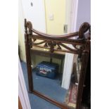 A ROSEWOOD MIRROR, the rectangular plate within a pillaster frame with linen draped cresting,