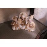 A GLAZED PORCELAIN ORIENTAL STYLE GROUP OF THREE SEATED FIGURES WITH MOVABLE HEADS